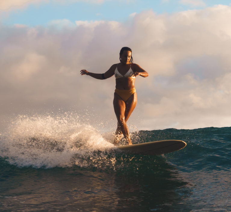 woman surfing at Playa Grande surf camp